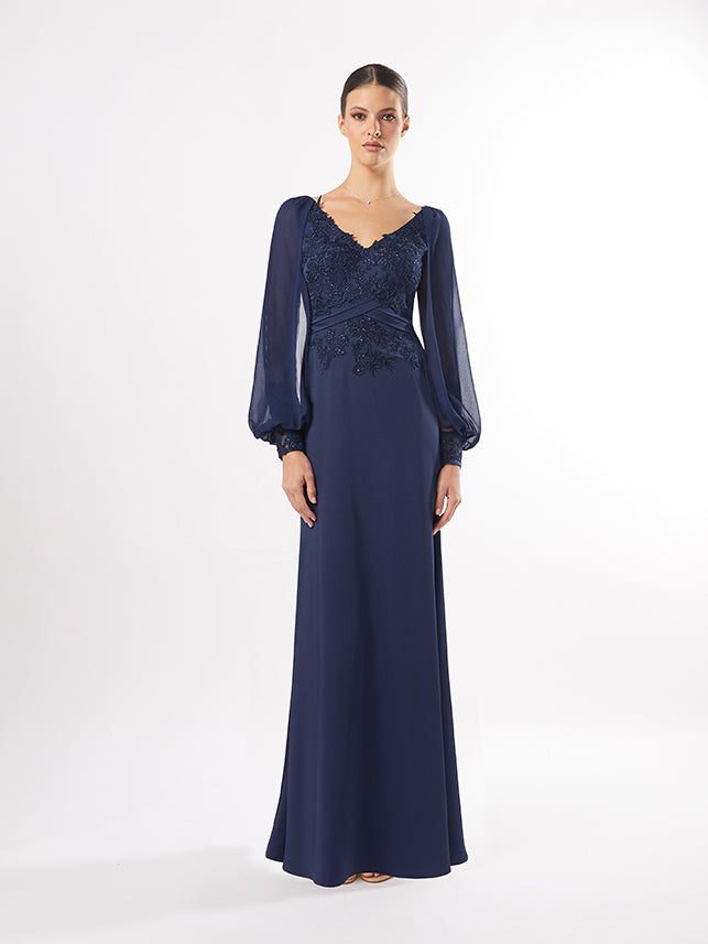 A model in an evening gown with lace embellishments and sheer sleeves, available in maroon and teal, posed against a white backdrop.