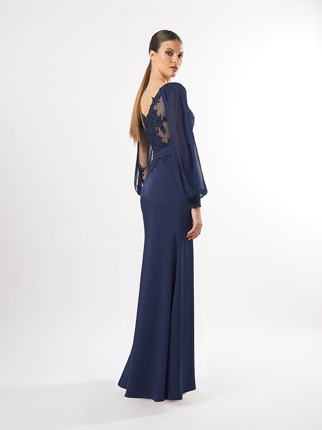 Back view of the gown showing the lace details and sheer sleeves, intended to represent the dress's maroon and teal versions.
