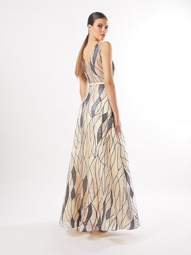 Rear view of the same gown, highlighting the open back and the continuous flow of the art deco pattern down the length of the dress.