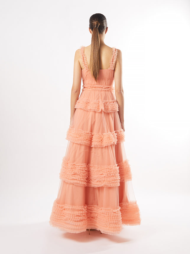 Back view of the same tiered gown, emphasizing the layered tulle and textured details, in peach (also in maroon and pistachio).