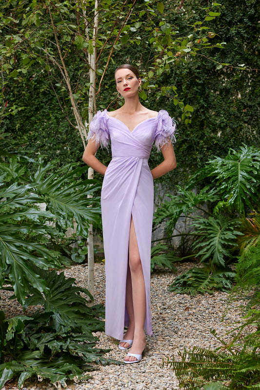 ront view of a model in a lilac (also available in dark fuchsia and turquoise) ruched evening gown with feathered shoulders and a deep V-neck.