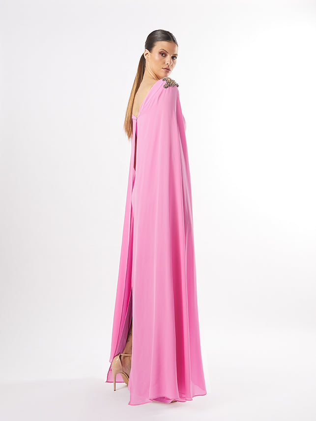 Rear view of the pink gown showing the drape of the cape sleeves and the elegant simplicity of the design, also offered in teal.