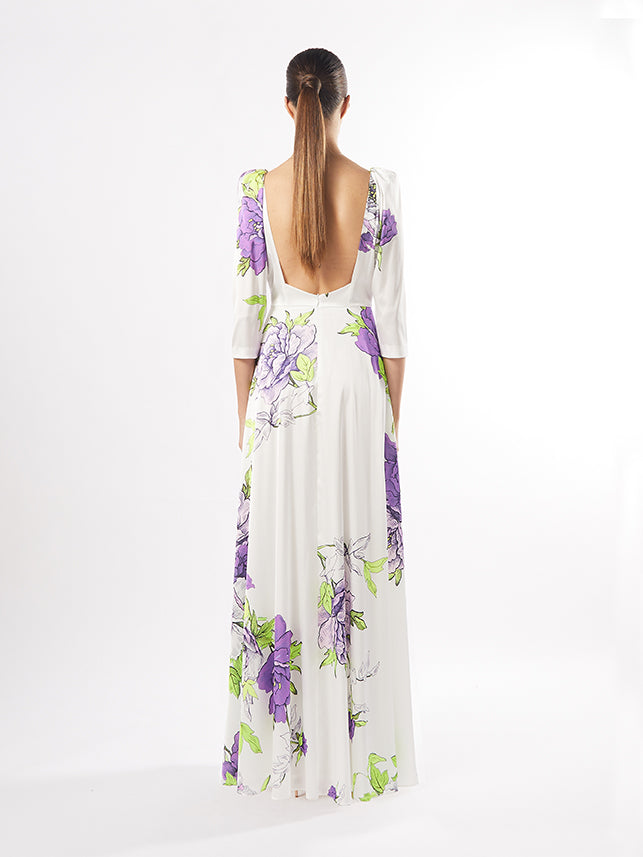 Model in an Elegant Floral Maxi Dress with a V-Neck and Long Sleeves, showcasing vibrant multipink and multigreen floral patterns on a flowy fabric."