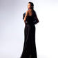 An elegant model displays the Enigmatic Noir Ruffle Gown, a black satin evening dress with a structured, sculptural ruffle bodice, and a high slit on the side, shown from multiple angles against a gradient background.